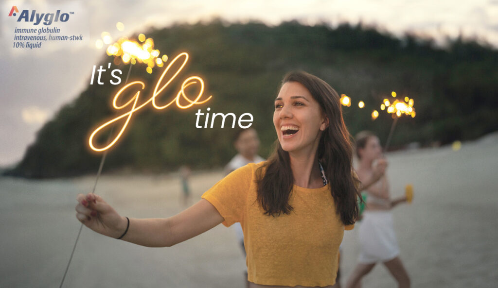 Woman on a beach holding a glowing sparkler stick. Text reads "It's Glo Time".